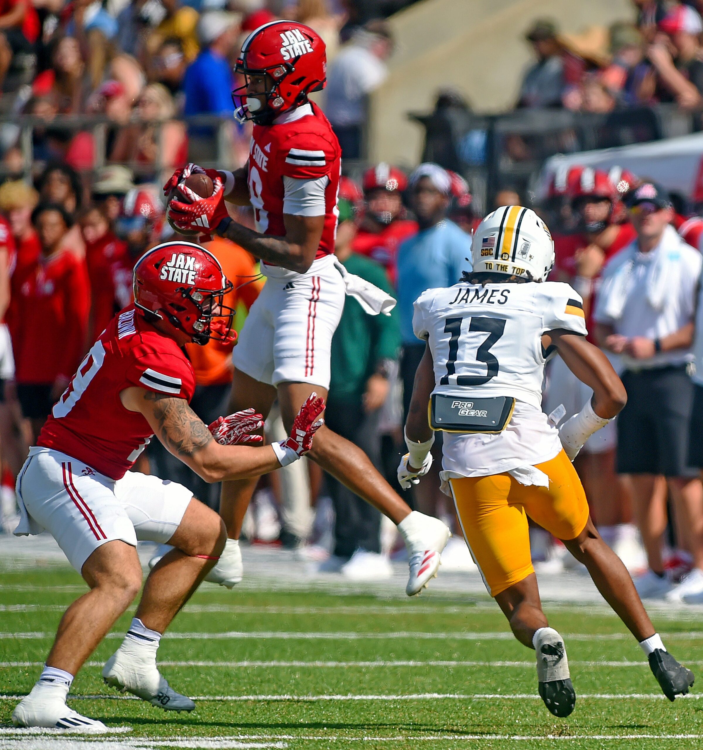 Jacksonville State's Cam Vaughn makes a catch as Southern Miss' Will James defends during college football action at Burgess-Snow Field AmFirst Stadium in Jacksonville, Alabama September 21, 2024.