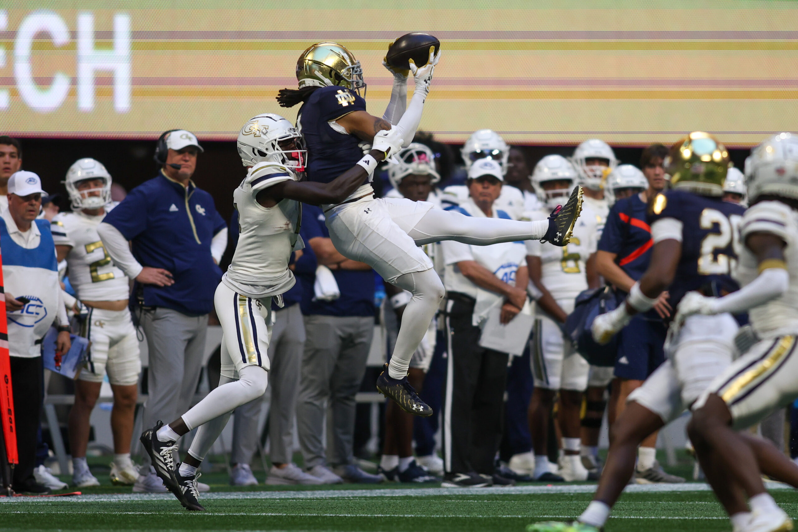 Oct 19, 2024; Atlanta, Georgia, USA; Notre Dame Fighting Irish safety Xavier Watts (0) intercepts a pass in front of Georgia Tech Yellow Jackets wide receiver Abdul Janneh Jr. (4) in the fourth quarter at Mercedes-Benz Stadium.