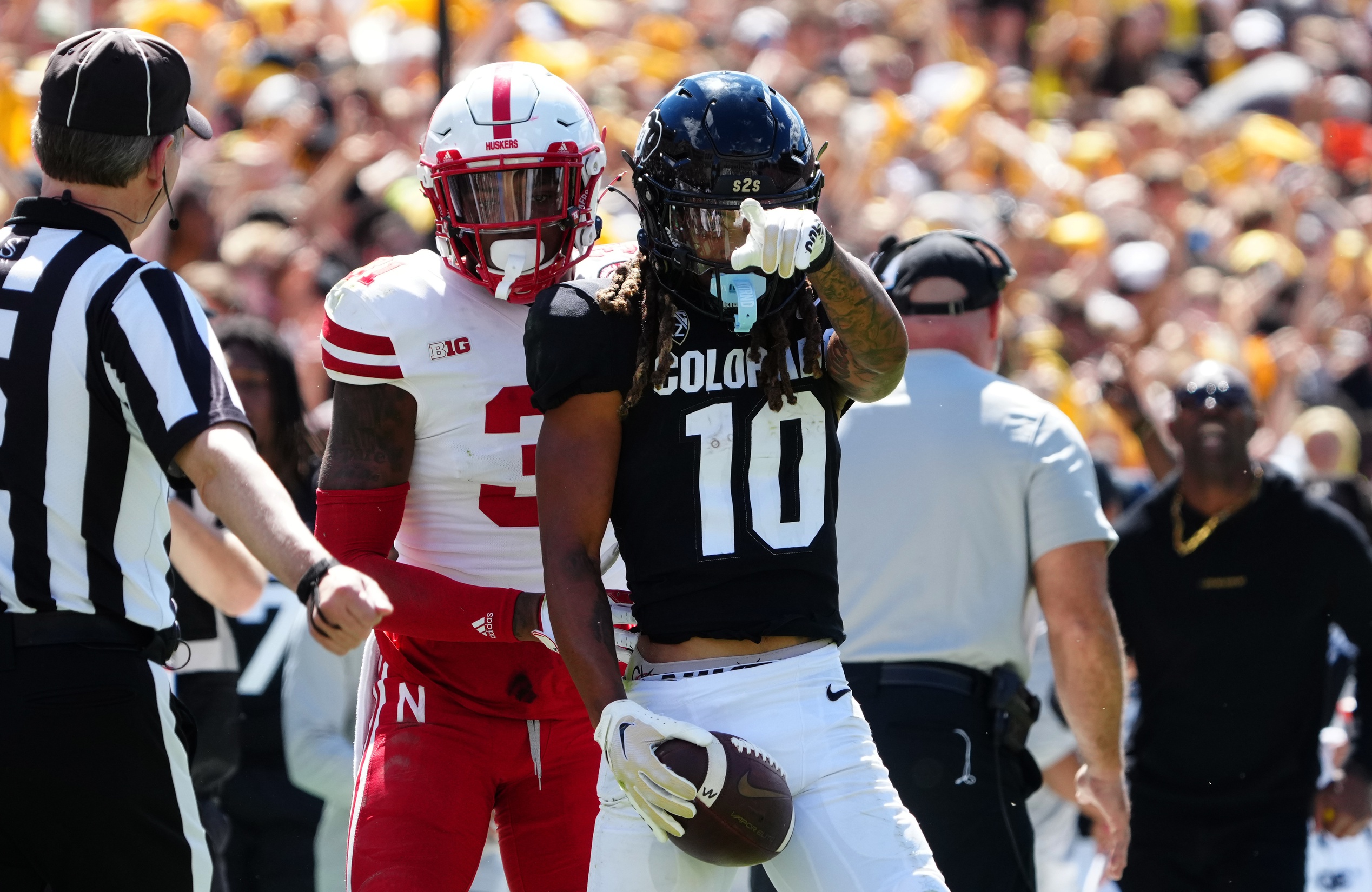 Sep 9, 2023; Boulder, Colorado, USA; Colorado Buffaloes wide receiver Xavier Weaver (10) reacts to his first down reception catch next to Nebraska Cornhuskers linebacker Nick Henrich (3) during the third quarter at Folsom Field.