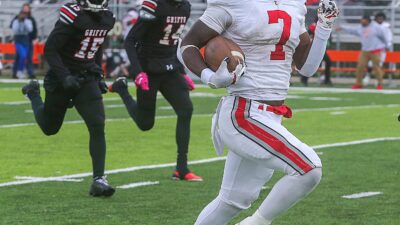 East running back Ziaire Stevens outruns two Buchtel defenders during a second-quarter 69-yard touchdown run on Saturday