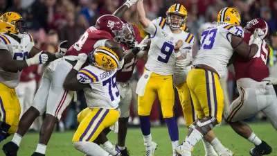 LSU quarterback Joe Burrow (9) throws the ball under pressure from Alabama defensive lineman Christian Barmore (58) at Bryant-Denny Stadium in Tuscaloosa