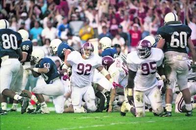 Alabama’s Mike Ramil (92) and Thomas Rayam (95) celebrate Rayam’s last second blocked field goal against Penn State in a game at Beaver Stadium in State College, PA, October 28, 1989. Alabama defeated Penn State 17-16.