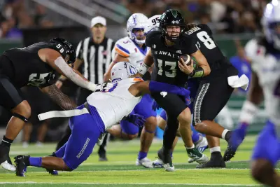 Penn State Nittany Lions quarterback Drew Allar (15) is sacked by Boise State Broncos linebacker Andrew Simpson (10) during their Vrbo Fiesta Bowl matchup at State Farm Stadium on Dec. 31, 2024.