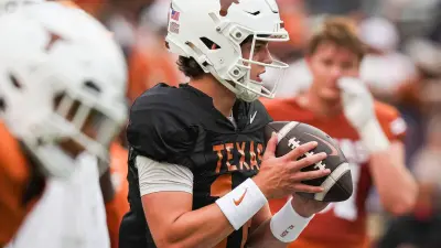 Texas Longhorns quarterback Arch Manning (16) looks for a pass while warming up ahead of the Longhorns' spring Orange and White game at Darrell K Royal Texas Memorial Stadium in Austin