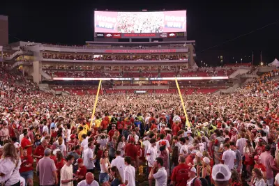 Oct 5, 2024; Fayetteville, Arkansas, USA; Arkansas Razorbacks fans celebrate in front of the downed goal posts after the game against the Tennessee Volunteers at Donald W. Reynolds Razorback Stadium. Arkansas won 19-14.