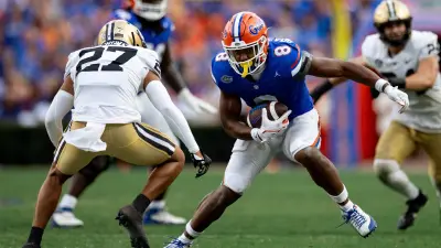 Caption: Florida Gators tight end Arlis Boardingham (8) runs with the ball after a catch against Vanderbilt Commodores safety John Howse IV (27) during the second half at Steve Spurrier Field at Ben Hill Griffin Stadium in Gainesville