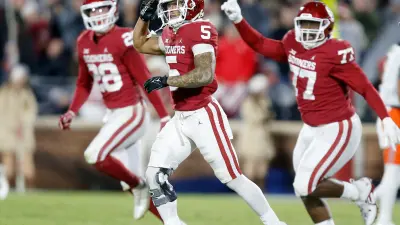 Oklahoma's Billy Bowman (5) celebrates an interception with Danny Stutsman (28) and Jeffery Johnson (77) in the first half during the Bedlam college football game between the University of Oklahoma Sooners (OU) and the Oklahoma State University Cowboys (OSU) at Gaylord Family-Oklahoma Memorial Stadium