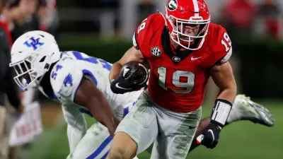Georgia tight end Brock Bowers (19) drives down the field after pulling in a pass from Georgia quarterback Carson Beck (15) during the second half of a NCAA college football game against Kentucky in Athens