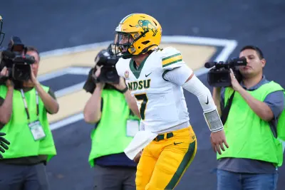 Caption: Aug 29, 2024; Boulder, Colorado, USA; North Dakota State Bison quarterback Cam Miller (7) celebrates his rushing touchdown in the second quarter against the Colorado Buffaloes at Folsom Field. 
