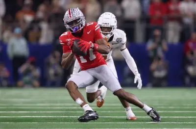 Jan 10, 2025; Arlington, Texas, USA; Ohio State Buckeyes wide receiver Carnell Tate (17) makes a catch against Texas Longhorns defensive back Malik Muhammad (5) during the second quarter of the College Football Playoff semifinal in the Cotton Bowl at AT&T Stadium.