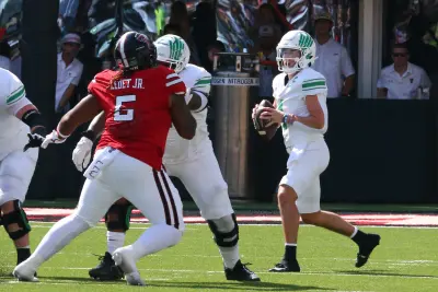 Sep 14, 2024; Lubbock, Texas, USA; North Texas Mean Green quarterback Chandler Morris (4) drops back to pass against Texas Tech Red Raiders defensive tackle Quincy Ledet Jr. (5) in the first half at Jones AT&T Stadium and Cody Campbell Field.