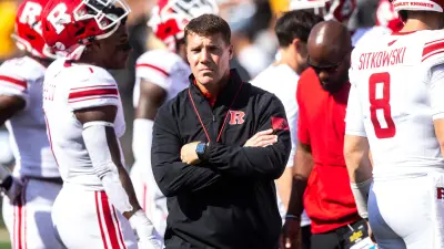Rutgers head coach Chris Ash watches players warm up before a NCAA Big Ten Conference football game against Rutgers