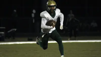 Fleming Island quarterback Cibastian Broughton (1) scrambles for yardage against Creekside during a high school football game on October 20