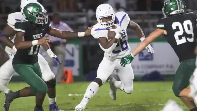 IMG running back Donovan Johnson (26) heads upfiled against Venice during their matchup at Powell-Davis Stadium in Venice.