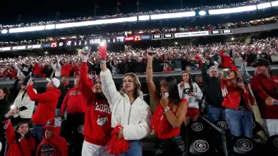 Georgia fans light up Sanford Stadium as the game goes into the fourth during the second half of a NCAA college football game against Kentucky in Athens