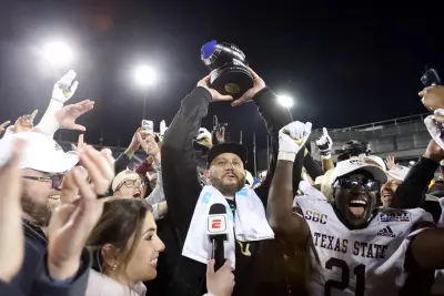 Dec 26, 2023; Dallas, TX, USA; Texas State Bobcats head coach GJ Kinne holds up the trophy after his team defeated the Rice Owls at Gerald J Ford Stadium.