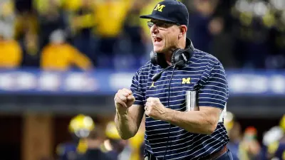 Michigan head coach Jim Harbaugh celebrates scoring a two point conversion against Purdue during the second half of the Big Ten Championship game against Purdue at Lucas Oil Stadium in Indianapolis