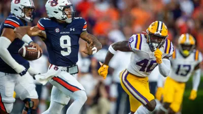 Auburn Tigers quarterback Robby Ashford (9) passes as LSU Tigers linebacker Harold Perkins Jr. (40) closes as the Auburn Tigers take on the LSU Tigers at Jordan-Hare Stadium in Auburn