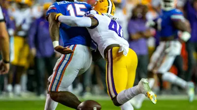 LSU Tigers linebacker Harold Perkins Jr. (40) clobbers Florida Gators quarterback Anthony Richardson (15) shaking loose the ball as Florida takes on LSU at Steve Spurrier Field at Ben Hill Griffin Stadium in Gainesville
