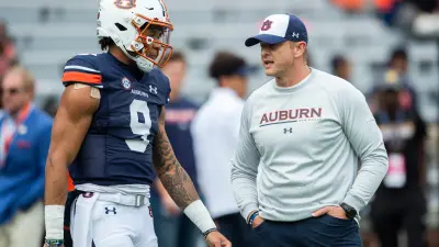 Auburn Tigers quarterback Robby Ashford (9) and Auburn Tigers head coach Bryan Harsin talk during warm ups before Auburn Tigers take on Arkansas Razorbacks at Jordan-Hare Stadium in Auburn