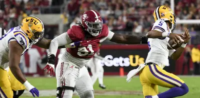 Nov 4, 2023; Tuscaloosa, Alabama, USA; LSU Tigers offensive lineman Miles Frazier (70) grabs a handful of Alabama Crimson Tide defensive lineman Jaheim Oatis (91) jersey as Oatis pressures LSU Tigers quarterback Jayden Daniels (5) at Bryant-Denny Stadium.