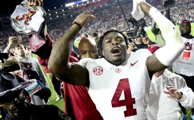 Nov 25, 2023; Auburn, Alabama, USA; Alabama Crimson Tide quarterback Jalen Milroe (4) celebrates after defeating the Auburn Tigers at Jordan-Hare Stadium. Alabama won 27-24.