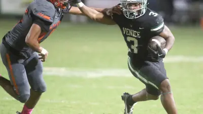 Venice runningback Jamarice Wilder (3) gets an edge on Sarasota Brian Klingel (45) during their matchup at Venice High School. Venice defeated Sarasota 44-14.