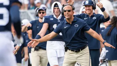 Penn State head football coach James Franklin holds out his hands to greet the offensive back to the sideline after a 4-yard touchdown pass from Beau Pribula to Omari Evans against Delaware Saturday