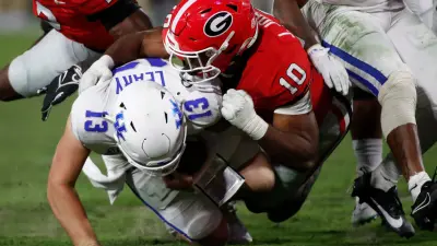 Georgia linebacker Jamon Dumas-Johnson (10) sacks Kentucky quarterback Devin Leary (13) during the second half of a NCAA college football game in Athens