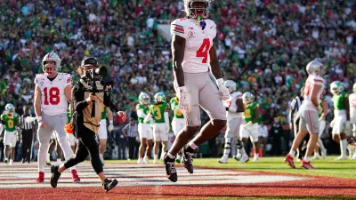 Ohio State Buckeyes wide receiver Jeremiah Smith (4) celebrates a touchdown during the first half of the College Football Playoff quarterfinal against the Oregon Ducks at the Rose Bowl in Pasadena
