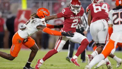 Oklahoma's Jovantae Barnes (2) runs past Oklahoma State's Kendal Daniels (5) during a Bedlam college football game between the University of Oklahoma Sooners (OU) and the Oklahoma State University Cowboys (OSU) at Gaylord Family-Oklahoma Memorial Stadium in Norman