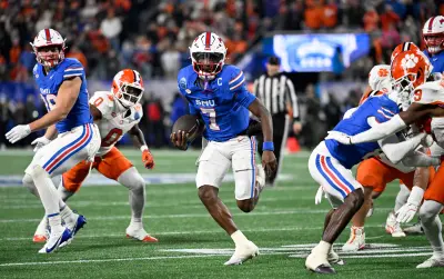 Dec 7, 2024; Charlotte, NC, USA; Southern Methodist Mustangs quarterback Kevin Jennings (7) runs for a touchdown during the first quarter against the Clemson Tigers in the 2024 ACC Championship game at Bank of America Stadium.