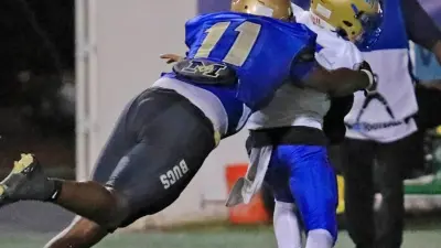Mainland's LJ McCray (11) makes a tackle during Thursday night's game against Osceola on Oct.19th