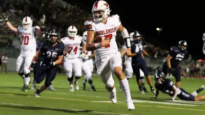 The Woodlands quarterback Mabrey Mettauer runs for a touchdown during the first half of a Region II-6A Division I area high school football playoff game against Klein Cain