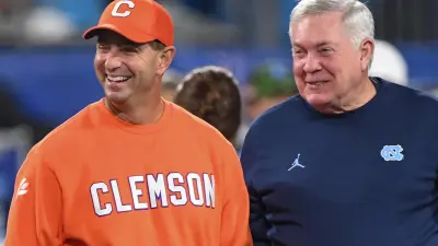 Clemson head coach Dabo Swinney and North Carolina Coach Mack Brown talk before the ACC Championship football game with North Carolina at Bank of America Stadium in Charlotte