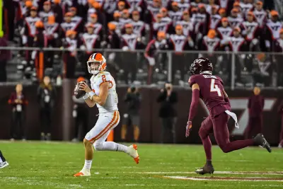 Nov 9, 2024; Blacksburg, Virginia, USA; Clemson Tigers quarterback Cade Klubnik (2) scrambles looking for a receiver while being pursued by Virginia Tech Hokies cornerback Mansoor Delane (4) during the third quarter at Lane Stadium.
