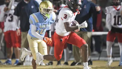 Belton-Honea Path junior Marquise Henderson (3) runs by DW Daniel junior Tremaine Davis
