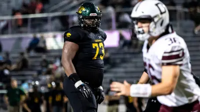 Cedar Rapids Kennedy's Nick Brooks (73) get set before a play during a Class 5A high school football game against Dowling Catholic