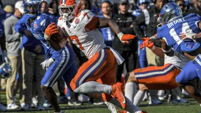 Clemson running back Phil Mafah (7) runs for the third of his four touchdowns against Kentucky during the fourth quarter of the TaxSlayer Gator Bowl at EverBank Stadium in Jacksonville