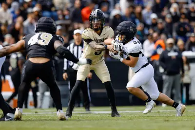 Apr 19, 2025; Boulder, CO, USA; Colorado Buffaloes quarterback Kaidon Salter (3) hands the ball off to running back Titus Bautista (34) as defensive end Quency Wiggins (49) defends during the spring game at Folsom Field.
