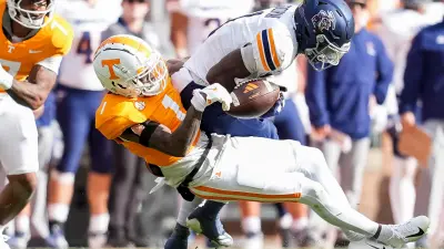 Tennessee defensive back Rickey Gibson III (1) strips the ball away from UTEP wide receiver Trey Goodman (1) during a college football game between Tennessee and UTEP at Neyland Stadium in Knoxville