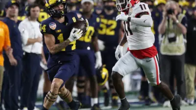 Michigan Wolverines wide receiver Roman Wilson (14) catches a pass against Georgia Bulldogs defensive back Derion Kendrick (11) during first half of the Capital One Orange Bowl game Friday