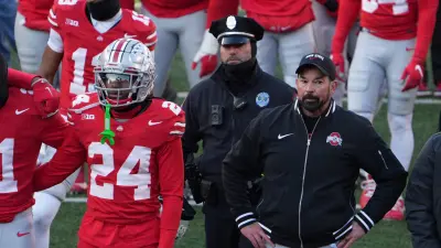 Ohio State University football coach Ryan Day tries to join the team to sing Carmen Ohio after the Michigan game Saturday