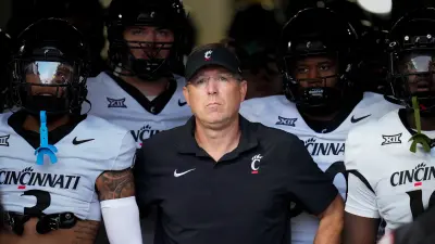 Cincinnati Bearcats head coach Scott Satterfield leads the Bearcats onto the field for the first quarter of the NCAA football game between the Pittsburgh Panthers and the Cincinnati Bearcats at Acrisure Stadium in Pittsburgh on Saturday