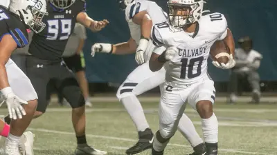 Calvary Christian School running back Sean Cuono (10) rushes the ball against Lakeland Christian School during the first half at Lakeland Christian School in Lakeland Friday night. October 21