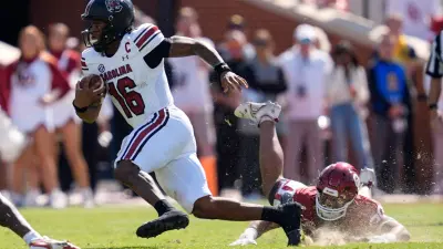 South Carolina Gamecocks quarterback LaNorris Sellers (16) runs past Oklahoma Sooners defensive lineman Trace Ford (30) during a college football game between the University of Oklahoma Sooners (OU) and the South Carolina Gamecocks at Gaylord Family - Oklahoma Memorial Stadium in Norman