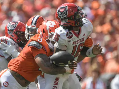 Sep 21, 2024; Clemson, South Carolina, USA; Clemson Tigersdefensive end T.J. Parker (3) hits North Carolina State Wolfpack quarterback CJ Bailey (16) to force a fumble during the first quarter at Memorial Stadium.