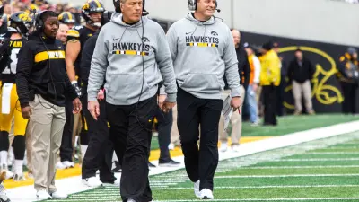 Iowa head coach Kirk Ferentz and Iowa offensive coordinator Brian Ferentz walk on the sideline during a Big Ten Conference NCAA football game on Friday