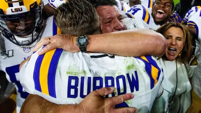 LSU head coach Ed Orgeron hugs quarterback Joe Burrow (9) after defeating Alabama at Bryant-Denny Stadium in Tuscaloosa