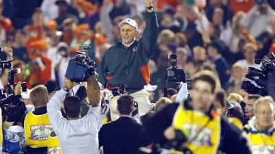 Miami head coach Larry Coker rides on his players' shoulders after the Hurricanes defeated Nebraska to win the 2001 national championship